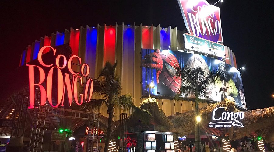 cocobongo-puntacana Exterior of Coco Bongo nightclub at night with illuminated signs and palm trees